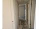 Standard hallway featuring neutral paint, a small closet, and multiple doorways at the end at 7940 E Camelback Rd # 712, Scottsdale, AZ 85251