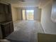 Open living space with sliding glass doors to balcony awaiting new flooring at 7940 E Camelback Rd # 712, Scottsdale, AZ 85251
