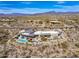 Aerial photograph of a desert luxury residence with a pool, patio, and sprawling desert landscape at 8145 E Tecolote Cir, Scottsdale, AZ 85266