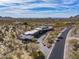 Expansive aerial view of desert property highlighting native vegetation and a private road leading to the estate at 8145 E Tecolote Cir, Scottsdale, AZ 85266