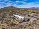 High-angle aerial view of a luxury home featuring desert landscaping, mountains, and a private pool area at 8145 E Tecolote Cir, Scottsdale, AZ 85266