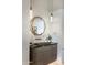 Modern powder room with geometric mirror, granite countertop, and pendant lighting at 8145 E Tecolote Cir, Scottsdale, AZ 85266