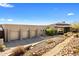 Elegant home featuring a spacious three-car garage and meticulously maintained desert landscaping at 8145 E Tecolote Cir, Scottsdale, AZ 85266