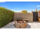 Outdoor fire pit area with stone seating, offering a cozy space for relaxation and socializing in a private setting at 8145 E Tecolote Cir, Scottsdale, AZ 85266