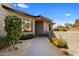 Charming home entrance with a paved walkway, manicured landscaping, and modern architectural details at 8145 E Tecolote Cir, Scottsdale, AZ 85266