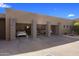 Spacious four-car garage featuring modern design with textured concrete and a paved driveway at 8145 E Tecolote Cir, Scottsdale, AZ 85266