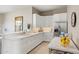 Bright kitchen with white cabinets, stainless steel refrigerator, and ample counter space for meal preparation and storage at 8145 E Tecolote Cir, Scottsdale, AZ 85266