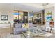 Comfortable living room with large windows, contemporary decor, and a sophisticated wine storage display at 8145 E Tecolote Cir, Scottsdale, AZ 85266