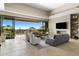 Open-concept living room with a fireplace, media center, and sliding glass doors to the outdoor pool area at 8145 E Tecolote Cir, Scottsdale, AZ 85266