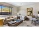 Comfortable living room with modern decor, large window with desert views, and neutral tones at 8145 E Tecolote Cir, Scottsdale, AZ 85266