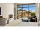 Comfortable main bedroom features fireplace, sitting area, and outdoor access at 8145 E Tecolote Cir, Scottsdale, AZ 85266