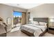 Comfortable main bedroom with a king bed, sliding glass door, stylish furniture, and serene outdoor views at 8145 E Tecolote Cir, Scottsdale, AZ 85266