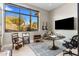 Desert views enhance this office with large window, round desk, and entertainment setup at 8145 E Tecolote Cir, Scottsdale, AZ 85266