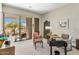 Bright office with a glass desk and a large sliding door to the outdoor patio at 8145 E Tecolote Cir, Scottsdale, AZ 85266