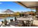 Luxurious pool area featuring comfortable lounge seating, umbrellas, and desert views, ideal for relaxation and recreation at 8145 E Tecolote Cir, Scottsdale, AZ 85266