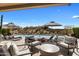 Inviting pool patio with comfortable seating, shade umbrellas, and stunning views of the surrounding desert landscape at 8145 E Tecolote Cir, Scottsdale, AZ 85266