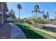 Manicured grounds feature mature landscaping, pathways, and towering palm trees for a serene setting at 9115 E Purdue Ave # 107, Scottsdale, AZ 85258