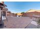 A cozy backyard oasis featuring a refreshing pool, brick patio, and charming hammock for outdoor relaxation at 9212 E Cedar Basin Ln, Gold Canyon, AZ 85118
