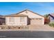 Charming single-story home featuring a two-car garage, neutral stucco exterior, and low-maintenance desert landscaping at 9212 E Cedar Basin Ln, Gold Canyon, AZ 85118
