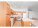 Spacious kitchen with wood cabinets, center island, and white appliances, providing ample storage and functionality at 9212 E Cedar Basin Ln, Gold Canyon, AZ 85118