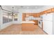 Functional kitchen with tile flooring, center island, and white appliances, perfect for everyday meal preparation at 9212 E Cedar Basin Ln, Gold Canyon, AZ 85118