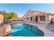 Backyard pool with patio, lounge chairs, mature trees, and serene ambiance, perfect for relaxation and entertainment at 9212 E Cedar Basin Ln, Gold Canyon, AZ 85118