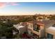 Aerial view of a luxurious home with a tile roof, well-manicured landscaping, and mountain views at 9270 E Thompson Peak Pkwy # 370, Scottsdale, AZ 85255