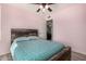 Bedroom with ceiling fan, wood headboard and doorway to another room at 951 W La Jolla Dr, Tempe, AZ 85282