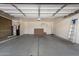 Spacious garage with water heater, ladder, and shelving; perfect for storage or workshop at 951 W La Jolla Dr, Tempe, AZ 85282
