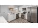 Bright kitchen with stainless steel appliances, ample counter space, and vinyl wood flooring at 951 W La Jolla Dr, Tempe, AZ 85282
