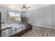 Comfortable main bedroom features a ceiling fan, neutral walls, and vinyl wood floors at 951 W La Jolla Dr, Tempe, AZ 85282
