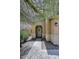 Inviting home entrance with an arched doorway and neutral-colored gravel landscaping at 9901 E Bahia Dr, Scottsdale, AZ 85260