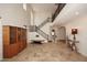 Bright foyer with high ceilings, tile floors, and a beautiful staircase with iron railings at 9901 E Bahia Dr, Scottsdale, AZ 85260