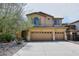 Charming two-story home with a three-car garage, well-manicured landscaping, and a neutral color palette at 9901 E Bahia Dr, Scottsdale, AZ 85260