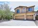 Inviting two-story home featuring a two-car garage and well-maintained landscaping at 9901 E Bahia Dr, Scottsdale, AZ 85260