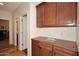 Hallway with custom built in cabinets, countertops, and hardwood floors at 9901 E Bahia Dr, Scottsdale, AZ 85260