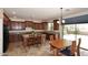 Open kitchen with granite counters, cabinets, and tile flooring leading to backyard access at 9901 E Bahia Dr, Scottsdale, AZ 85260