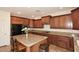Spacious kitchen featuring granite countertops, stainless steel appliances, and center island at 9901 E Bahia Dr, Scottsdale, AZ 85260