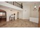 Spacious living room with an open floor plan, travertine flooring, and staircase with iron railings at 9901 E Bahia Dr, Scottsdale, AZ 85260