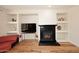 Comfortable living room featuring built in shelves, hardwood floors, and a fireplace at 9901 E Bahia Dr, Scottsdale, AZ 85260