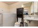 Bathroom with white tile, vanity, toilet and mirror at 1015 N 193Rd Ave, Buckeye, AZ 85326