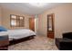 Bedroom with beige walls, tile flooring, with two mirrors on the walls at 1015 N 193Rd Ave, Buckeye, AZ 85326