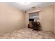 Bedroom with beige walls, tile flooring, desk and chair at 1015 N 193Rd Ave, Buckeye, AZ 85326