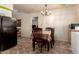 Bright dining room with wood table, chandelier lighting, and easy access to the kitchen at 1015 N 193Rd Ave, Buckeye, AZ 85326