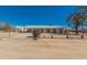 Property featuring a fence and desert landscaping under a bright blue sky at 1015 N 193Rd Ave, Buckeye, AZ 85326