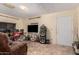 Cozy room with tile flooring, a TV, and direct access to an exterior door at 1015 N 193Rd Ave, Buckeye, AZ 85326