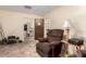 Relaxing living room featuring a comfortable recliner and view to the bathroom and dining area at 1015 N 193Rd Ave, Buckeye, AZ 85326