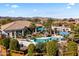 Expansive aerial view of a home with a private pool, lush landscaping, and mountain views, showcasing outdoor living at 10417 N 180Th Dr, Waddell, AZ 85355