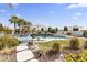 Backyard view featuring a luxurious pool, lush landscaping, and comfortable seating areas for relaxing at 10417 N 180Th Dr, Waddell, AZ 85355