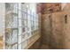 Bathroom featuring a shower with glass block and a hand shower at 10417 N 180Th Dr, Waddell, AZ 85355